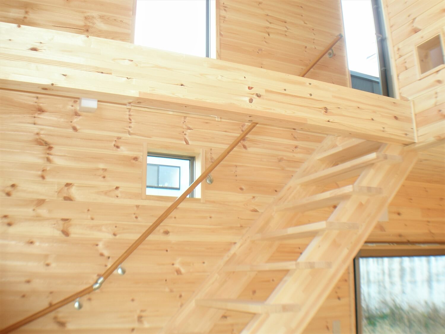 大きな高窓のある二階建ての梁と階段｜瀬戸市の注文住宅,ログハウスのような低価格住宅を建てるならエイ・ワン